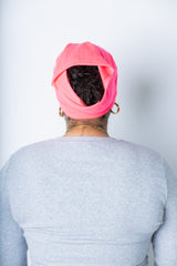 a woman wearing a neon pink undercap for hijab