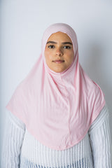 a woman wearing a light pink jersey slip on one piece hijab