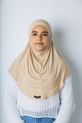 woman wearing a tan one piece slip on hijab