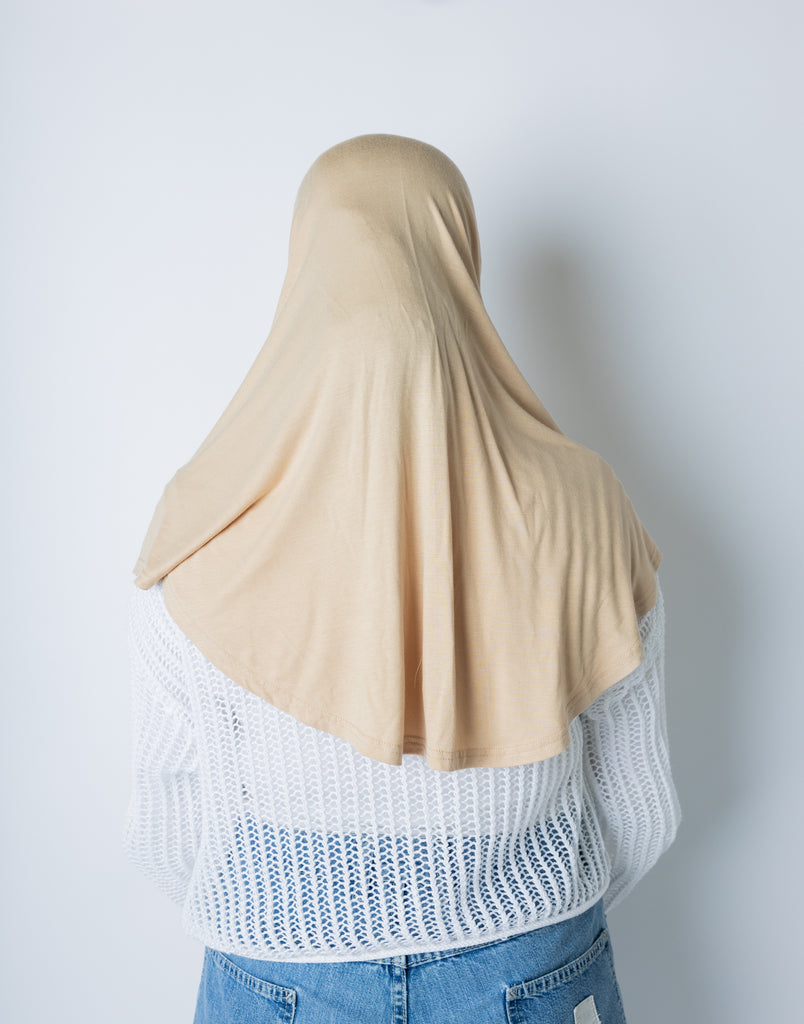 woman wearing a tan one piece slip on hijab