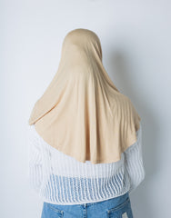 woman wearing a tan one piece slip on hijab