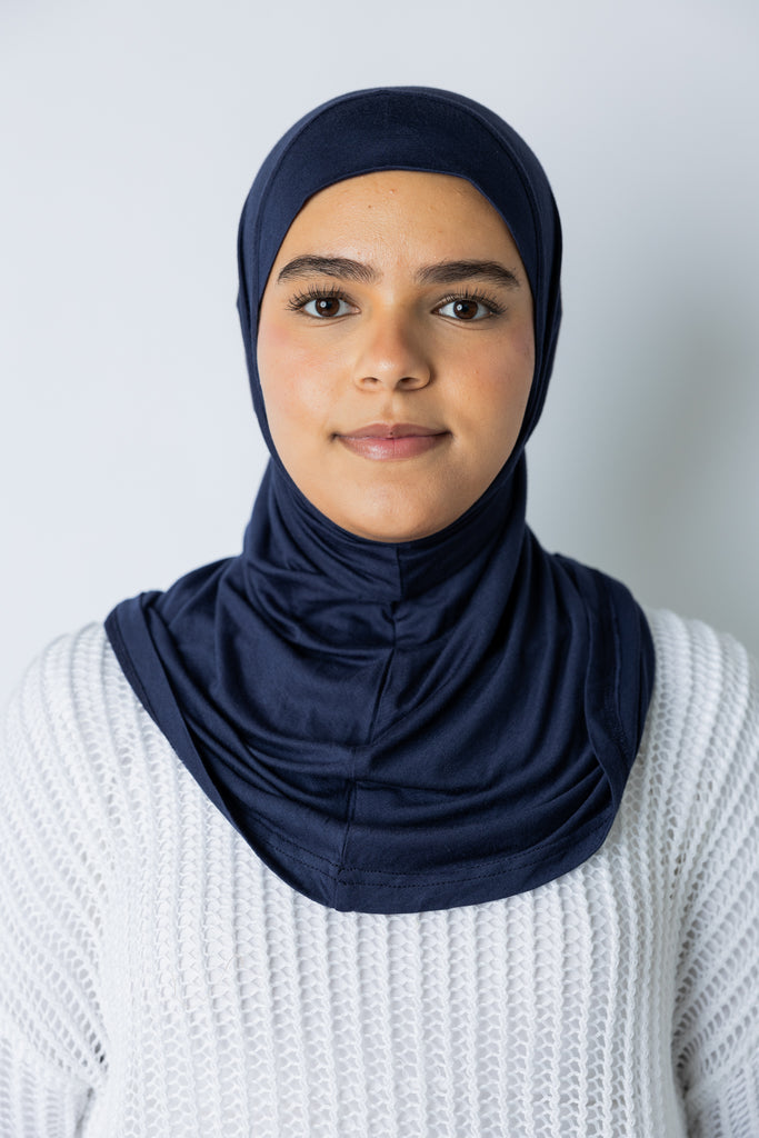 woman wearing a navy blue jersey slip on one piece hijab