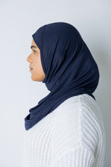 woman wearing a navy blue jersey slip on one piece hijab