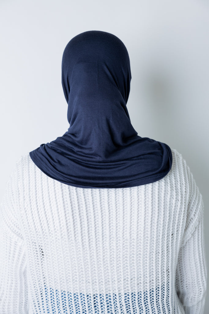 woman wearing a navy blue jersey slip on one piece hijab