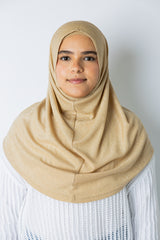 woman wearing a gold shimmer two piece amira slip on hijab