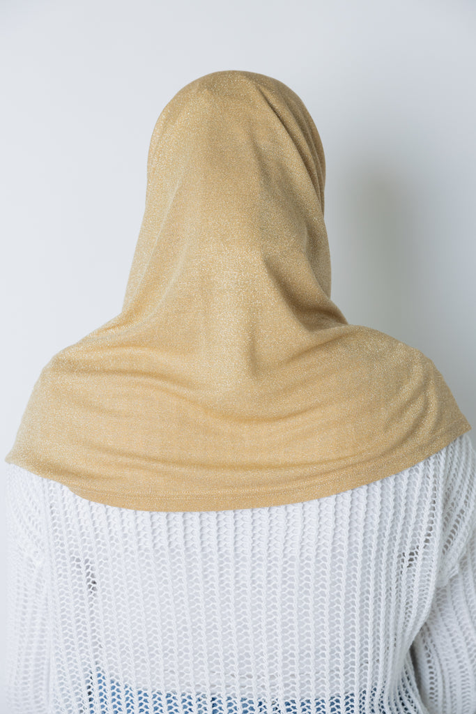 woman wearing a gold shimmer two piece amira slip on hijab