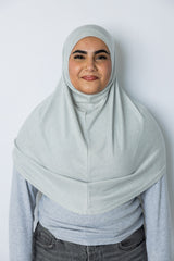 woman wearing a silver shimmer two piece amira slip on hijab