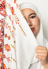 woman wearing white modal hijab with tatreez Palestinian pattern motifs 