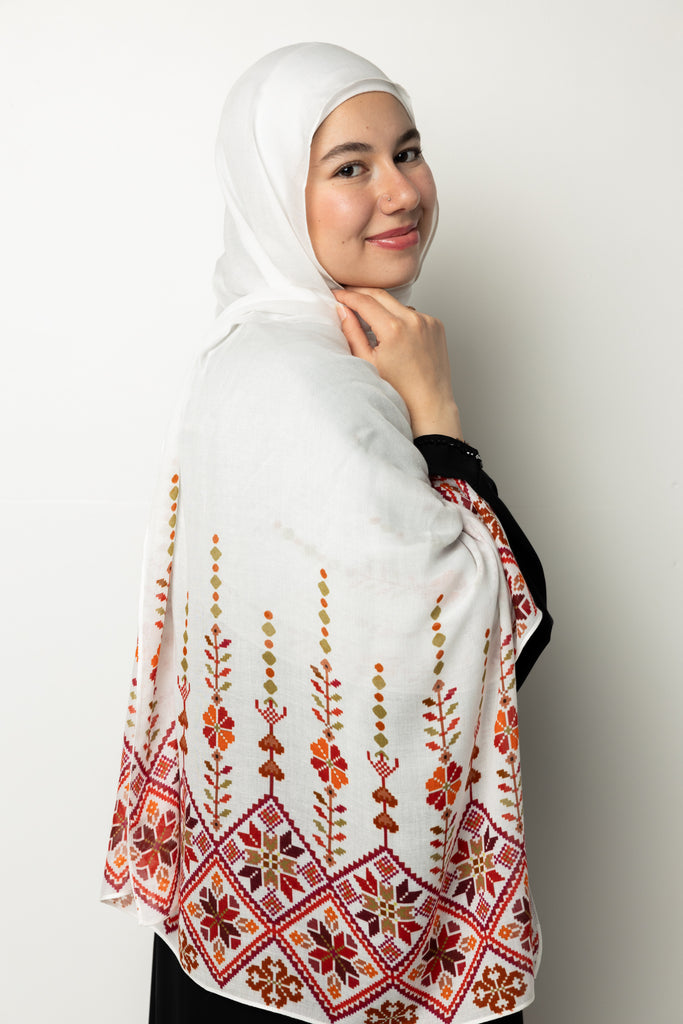 woman wearing white modal hijab with tatreez Palestinian pattern motifs 