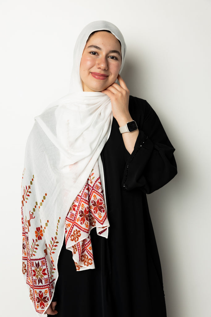 woman wearing white modal hijab with tatreez Palestinian pattern motifs 