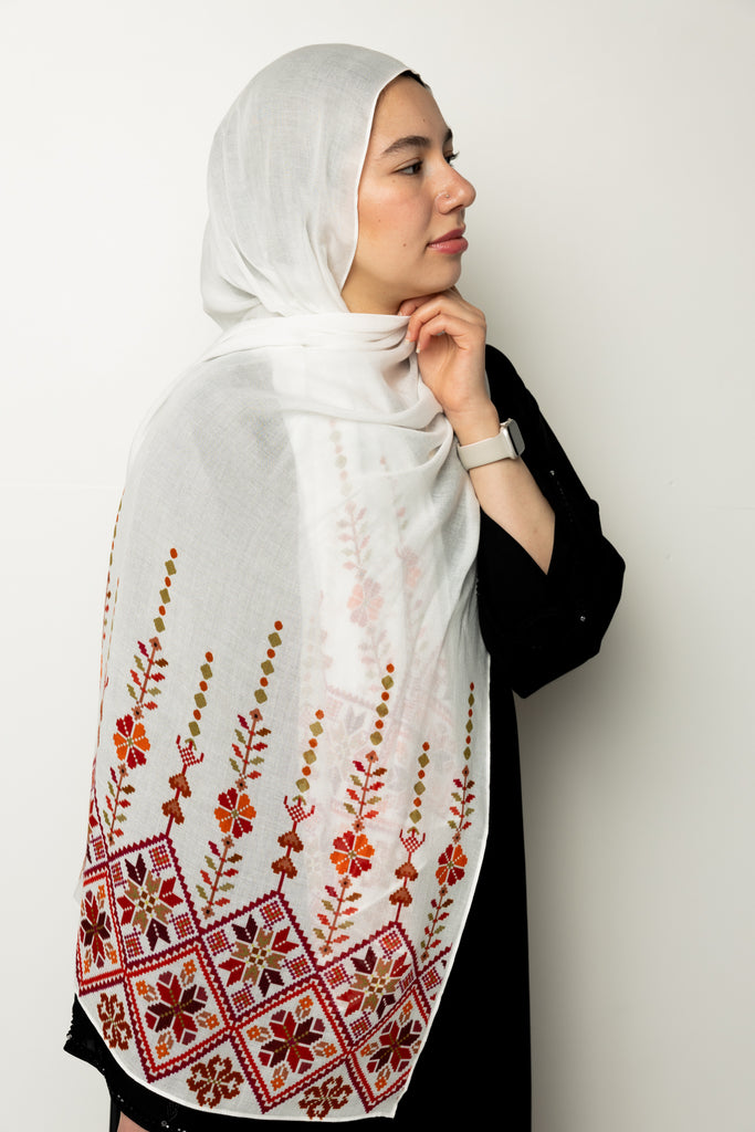 woman wearing white modal hijab with tatreez Palestinian pattern motifs 