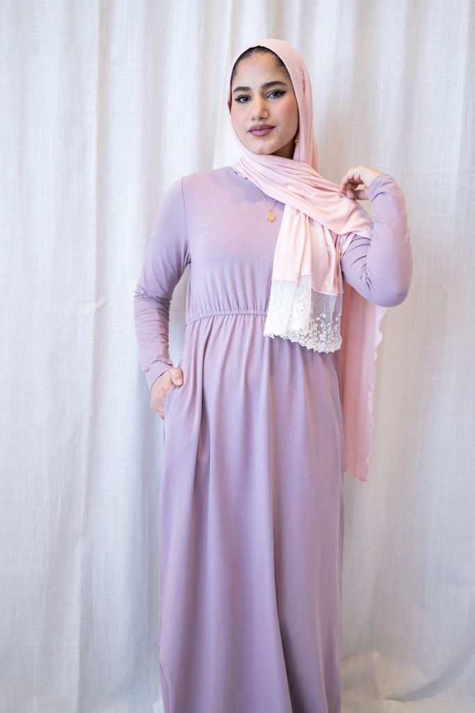 muslim woman wearing a lavender long sleeve maxi dress