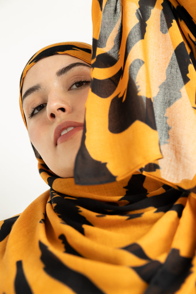 Tiger Stripes modal hijab, a striking blend of deep gold and bold black 