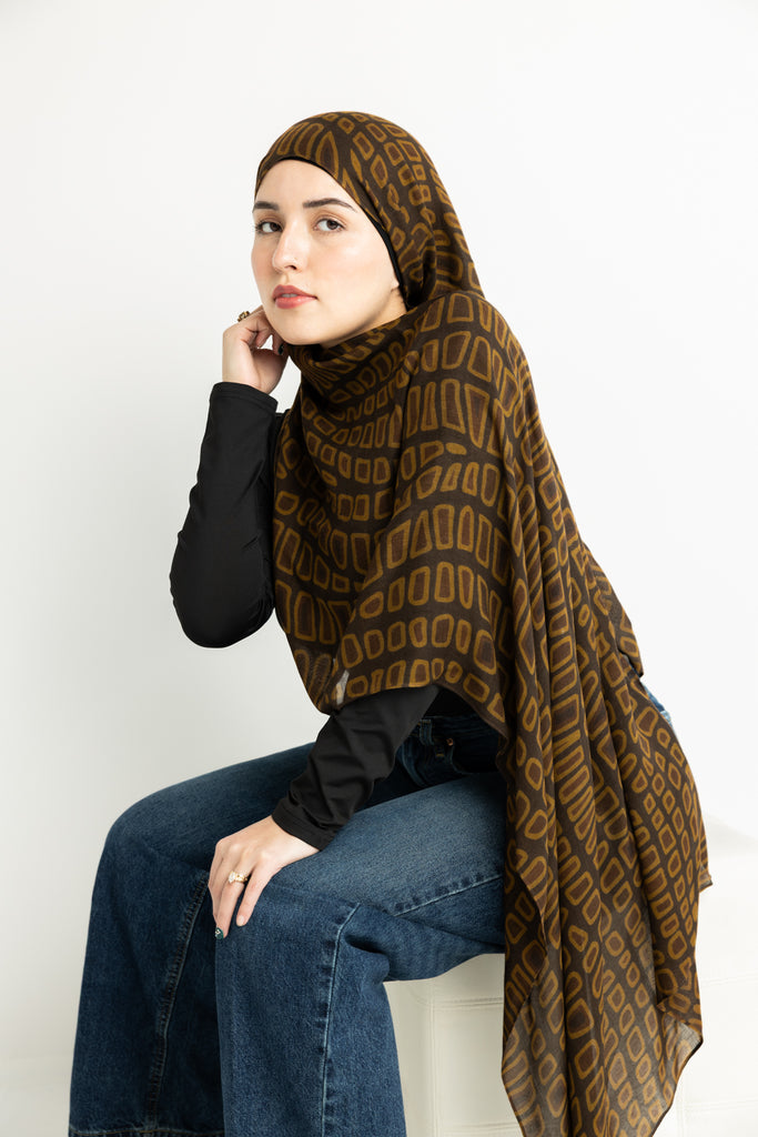 crocodile skin-inspired modal hijab print in warm brown hues.