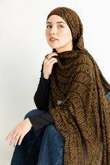 crocodile skin-inspired modal hijab print in warm brown hues.