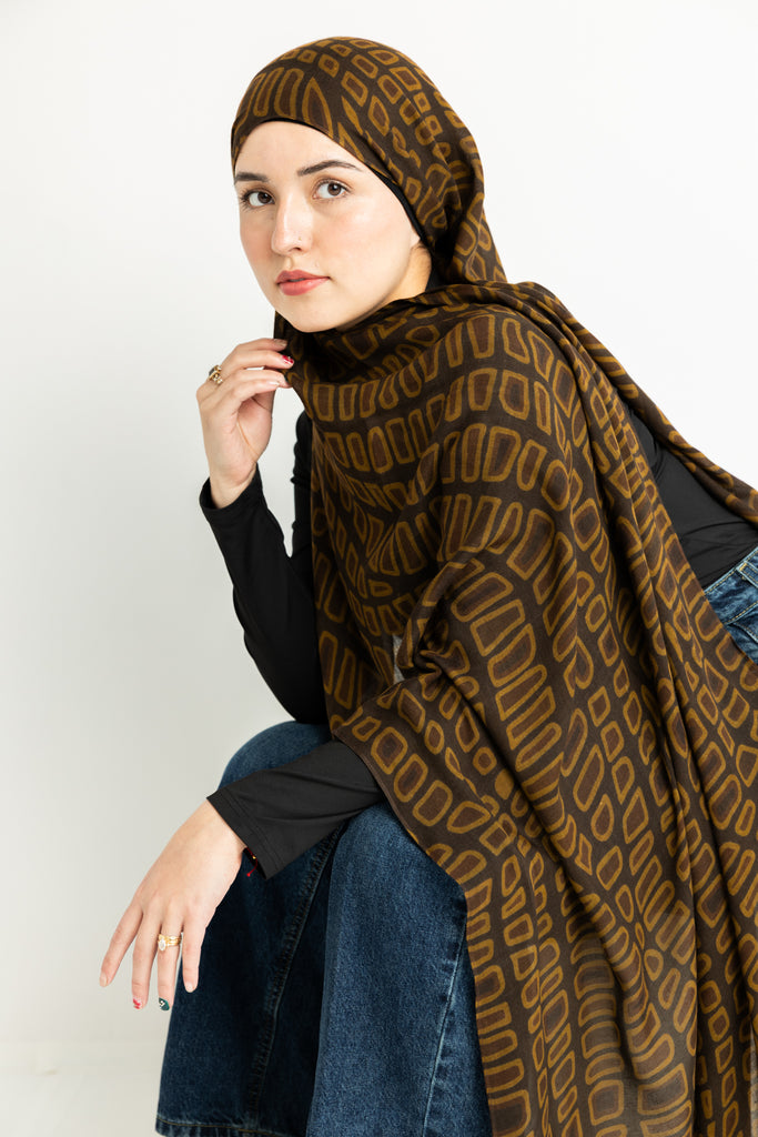 crocodile skin-inspired modal hijab print in warm brown hues.