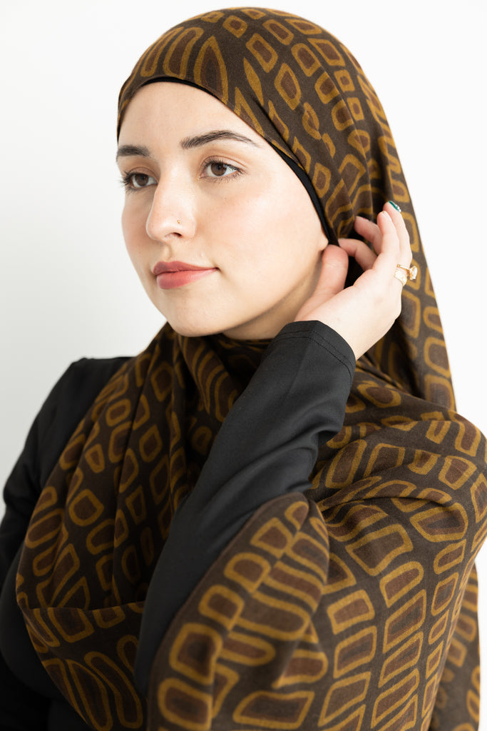 crocodile skin-inspired modal hijab print in warm brown hues.