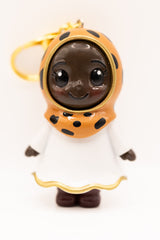 dark skinned cocoa hijabi figurine in cheetah print hijab on golden keychain