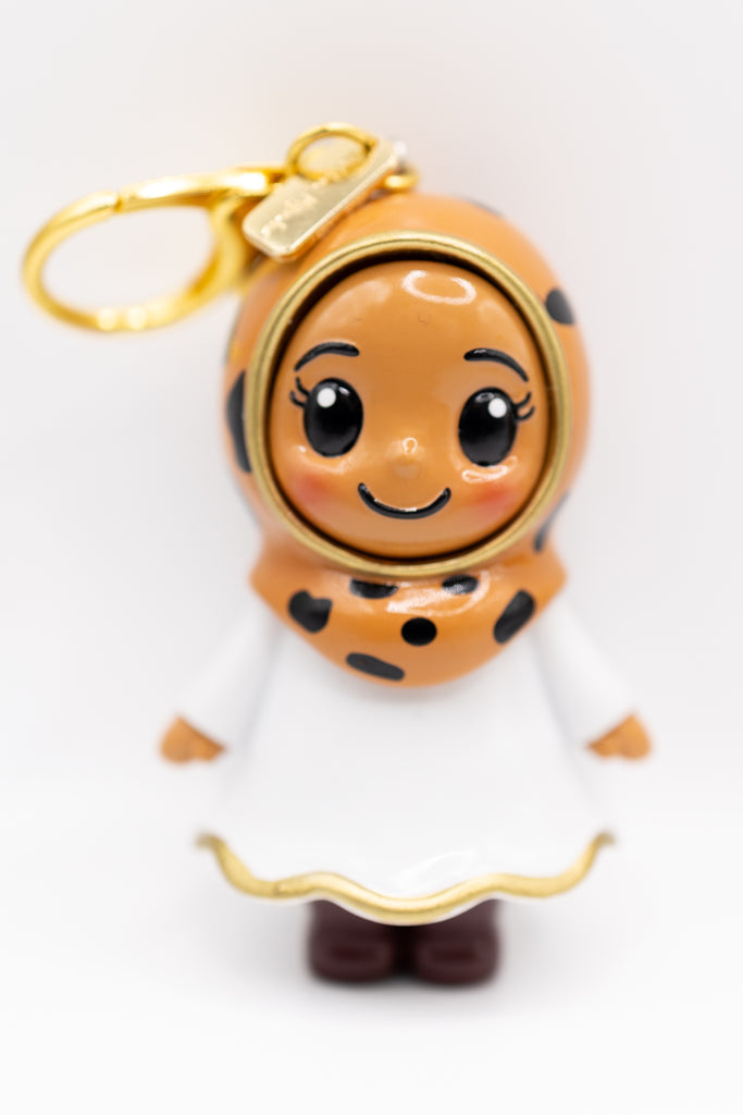 olive toned honey hijabi figurine in cheetah print hijab on golden keychain