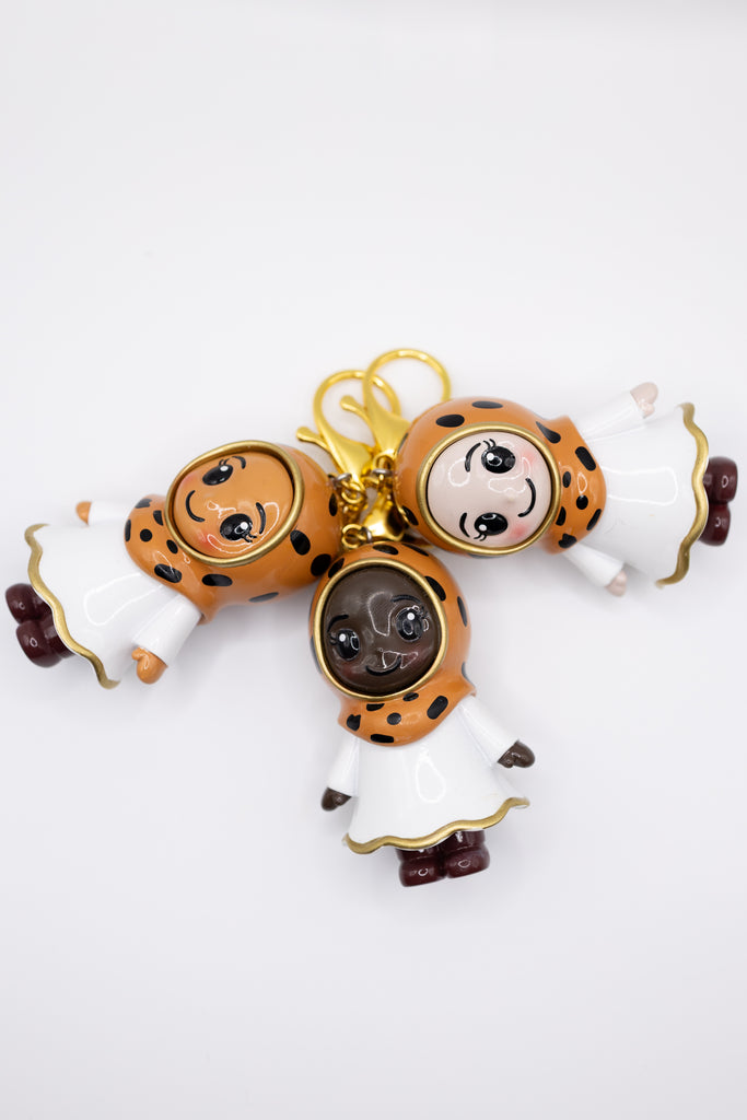 Decorative keychain with hijabi cartoon character design on a white background