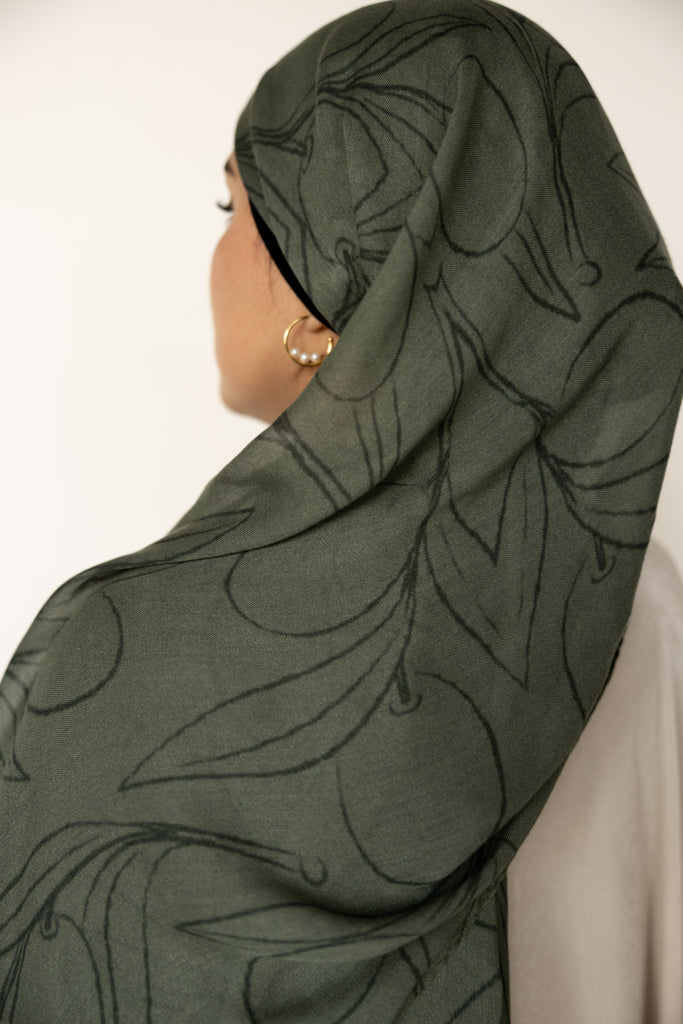 woman wearing olive green modal print hijab with olives and olive leaves branches Palestinian design 