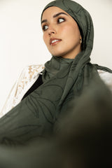 woman wearing olive green modal print hijab with olives and olive leaves branches Palestinian design 