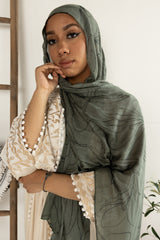 woman wearing olive green modal print hijab with olives and olive leaves branches Palestinian design 