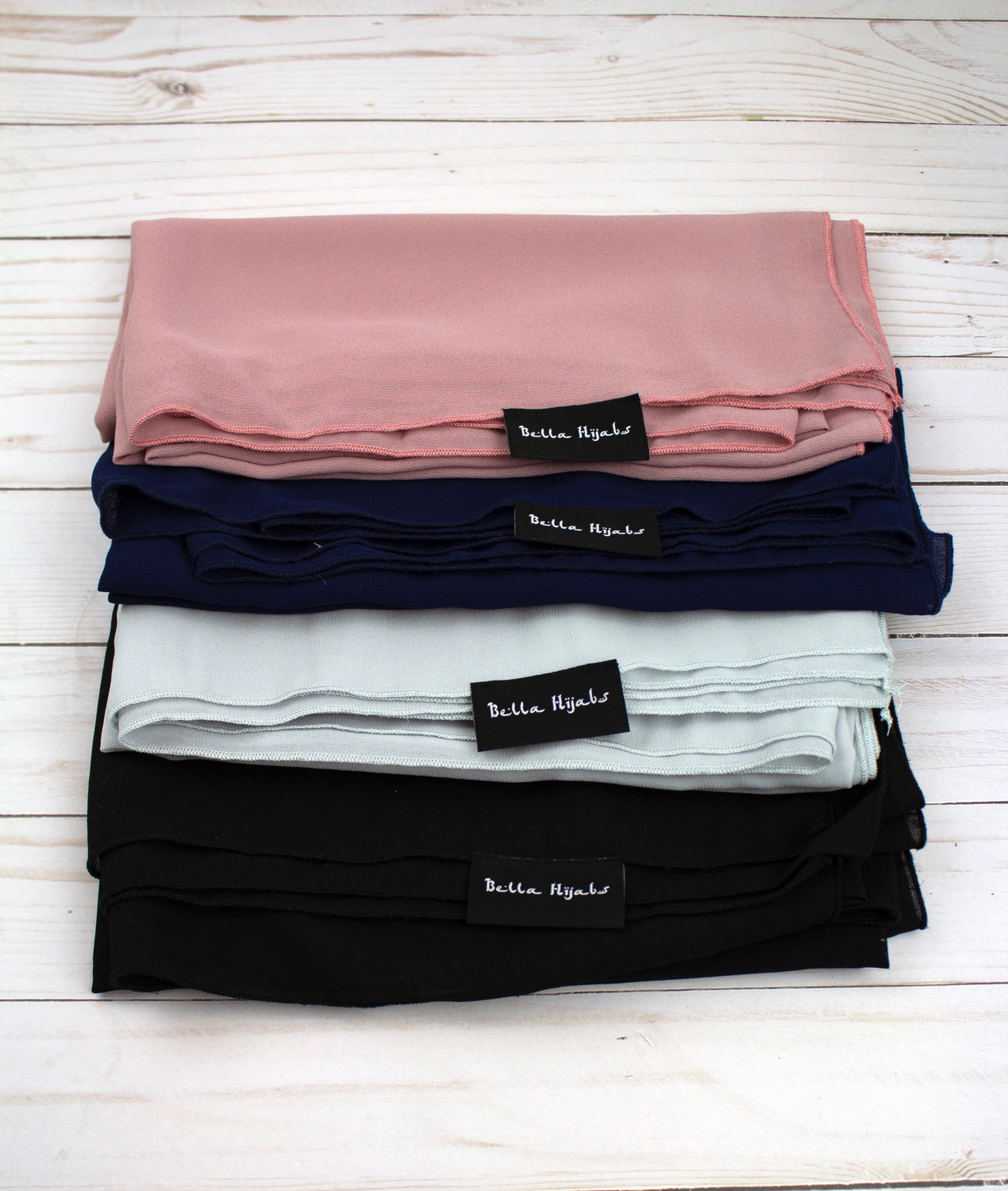 four chiffon square hijabs in mauve, black, navy, and silver
