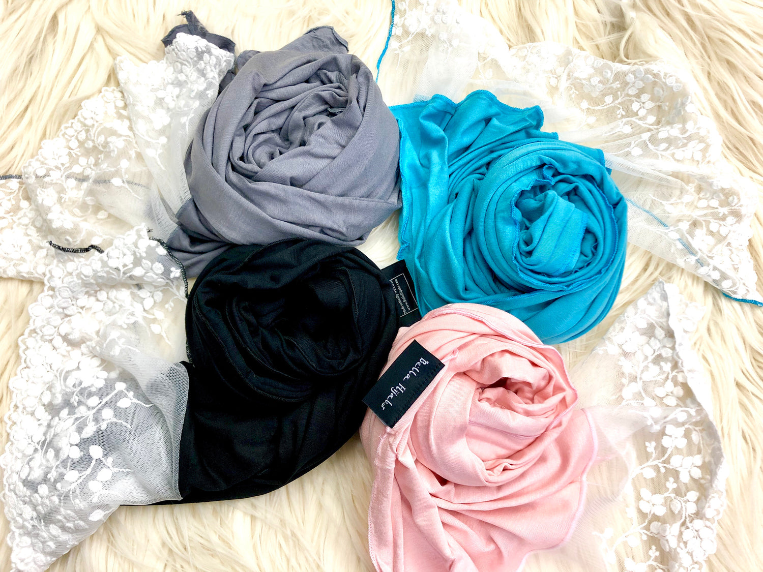 four jersey hijabs with lace in black, pink, gray, and blue