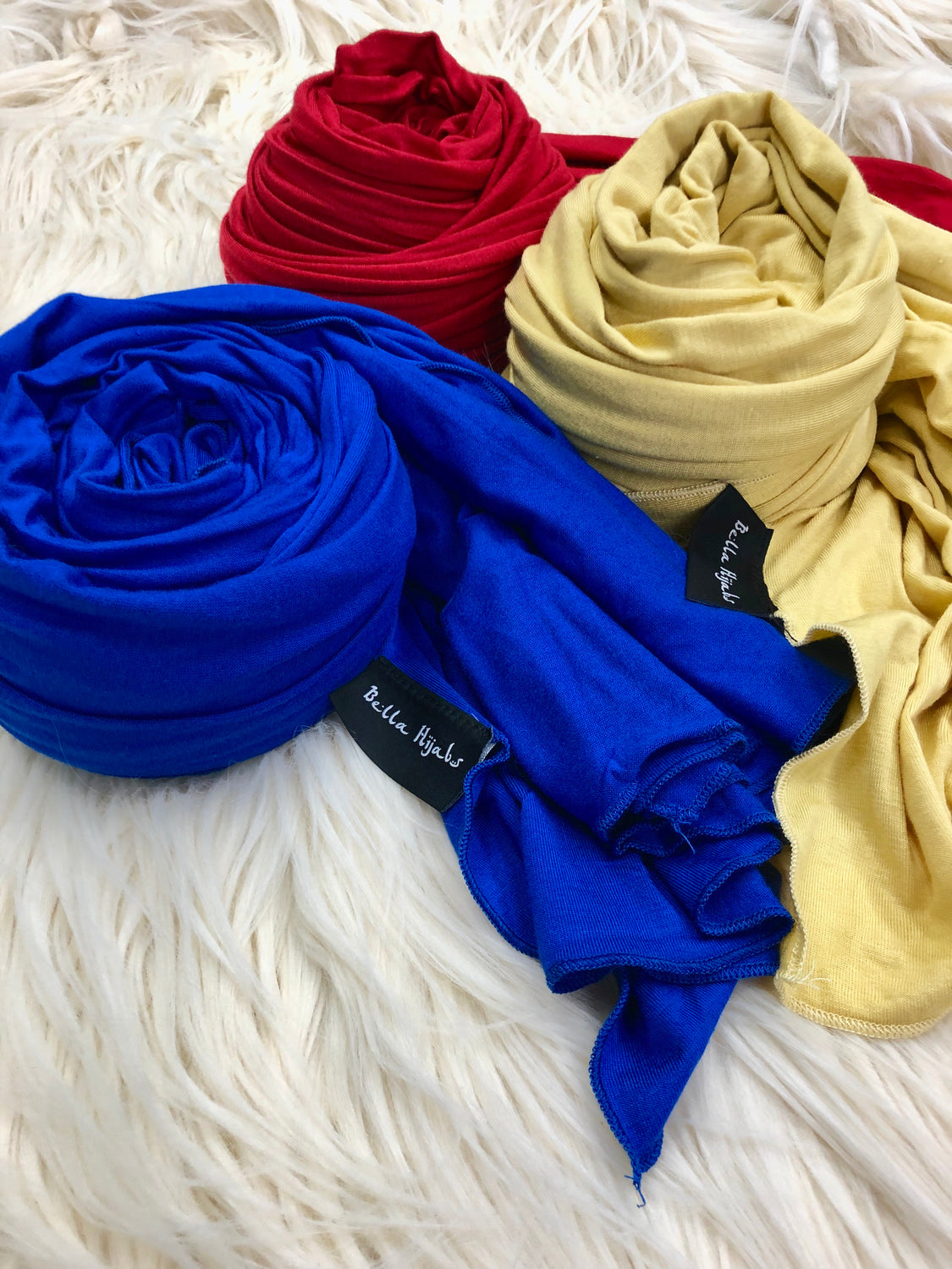 three jersey hijabs in primary colors red blue and yellow