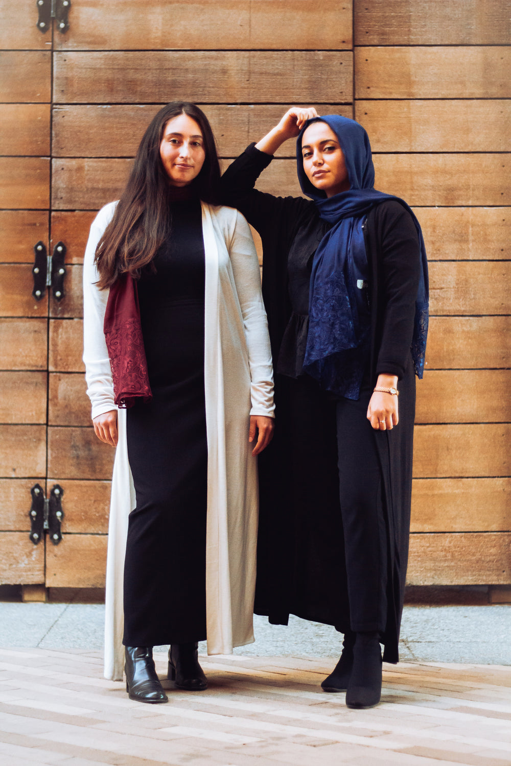 two muslim girls friends wearing black long sleeve maxi cardigan and a white long sleeve maxi cardigan with pockets