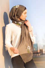 muslim woman wearing a dark gray floral embroidered hijab