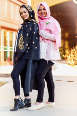 two muslim friends wearing embroidered hijabs in black and gold, and rose and white