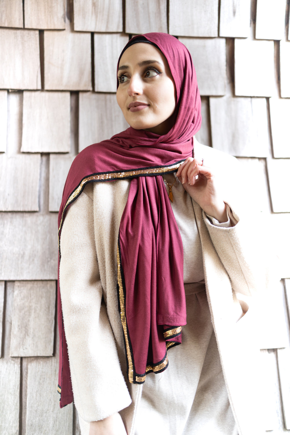 maroon jersey hijab embellished with a gold trim along the edges