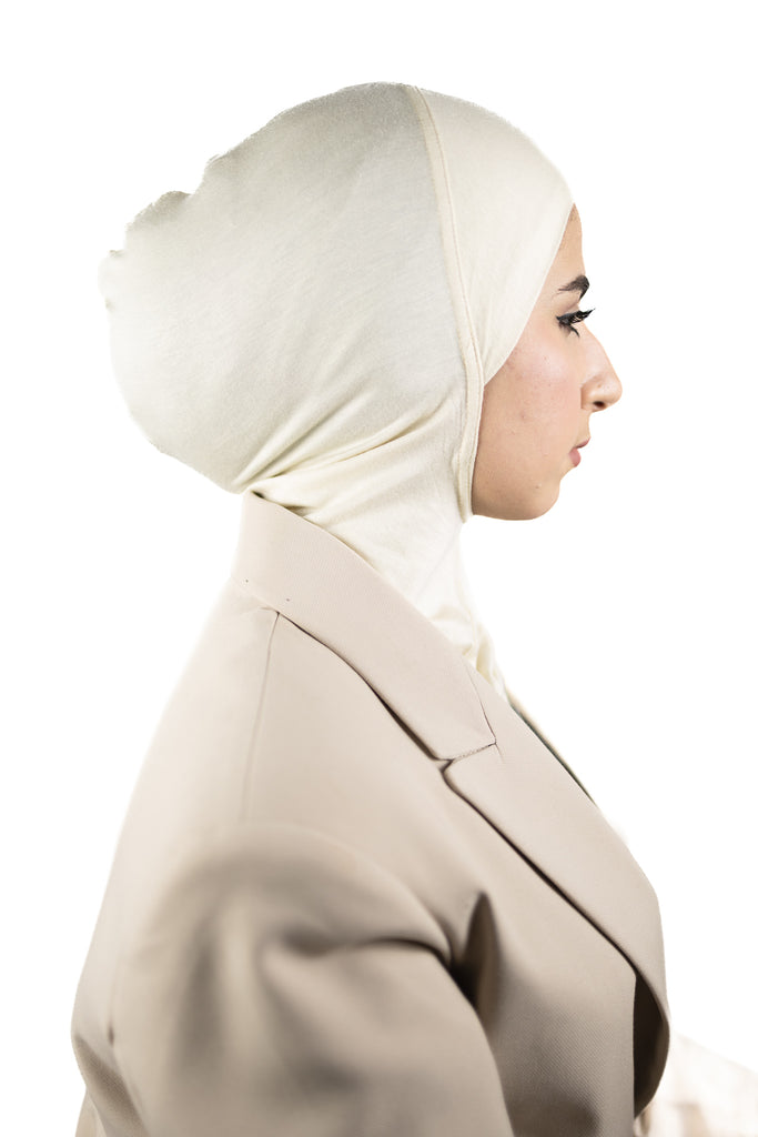 muslim woman wearing a beige blazer and ivory cream ninja underscarf