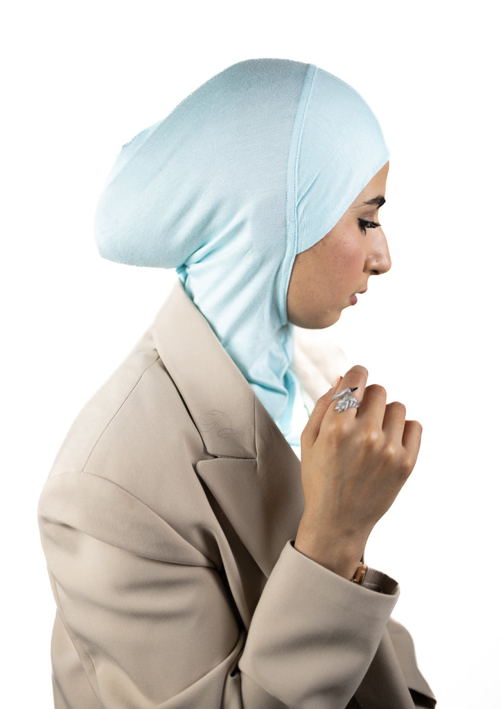 muslim woman wearing a beige blazer and baby blue ninja underscarf