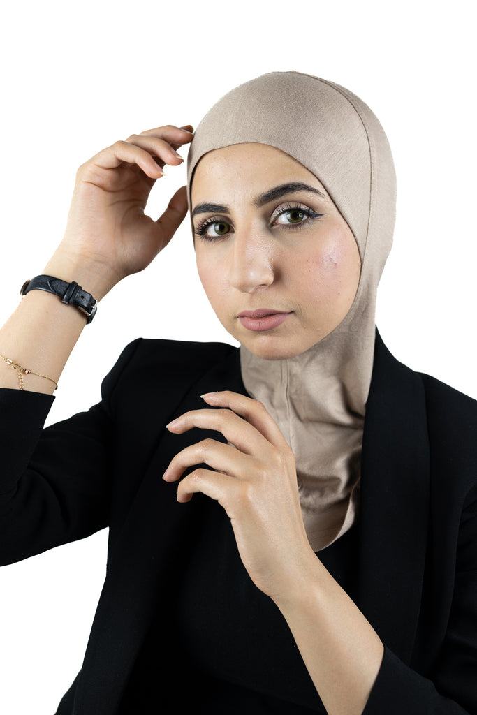 muslim woman wearing a black blazer and taupe ninja underscarf