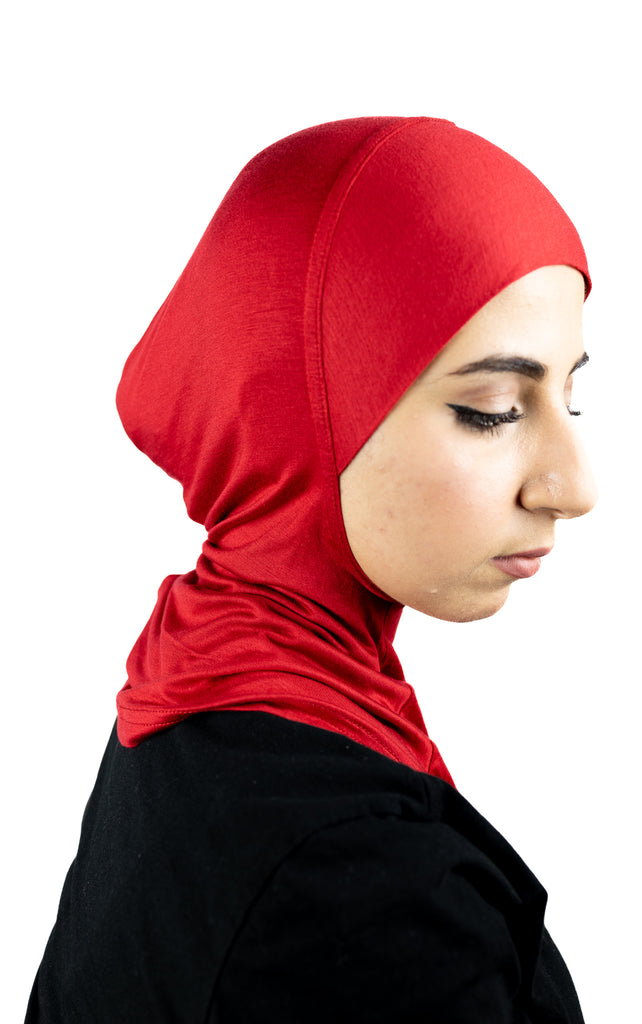 muslim woman wearing a beige blazer and red ninja underscarf