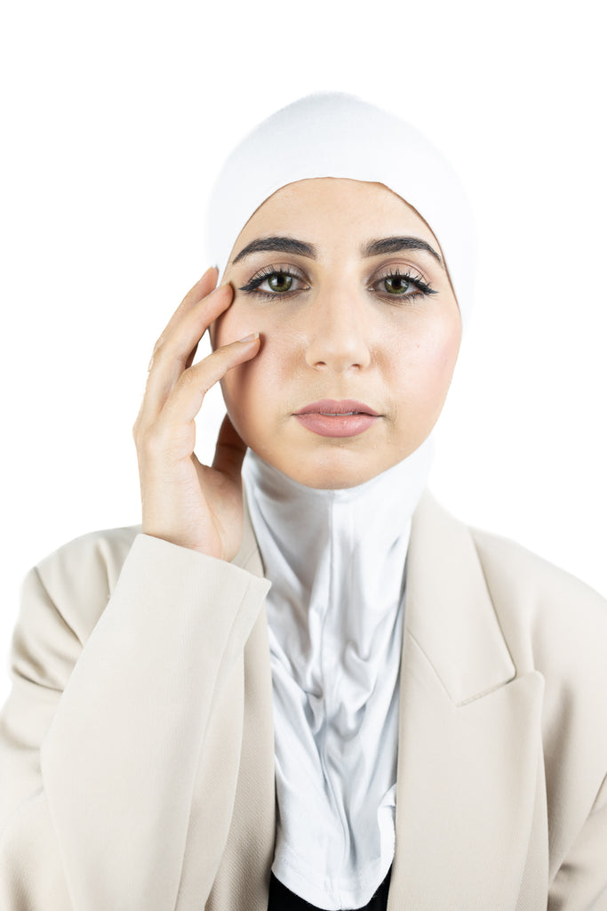 muslim woman wearing a beige blazer and white ninja underscarf