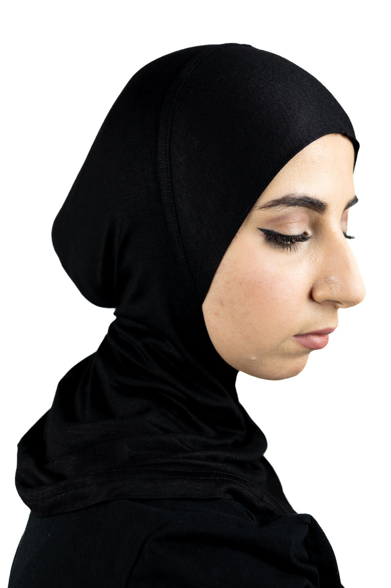 muslim woman wearing a beige blazer and black ninja underscarf
