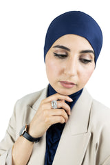 muslim woman wearing a beige blazer and navy blue ninja underscarf