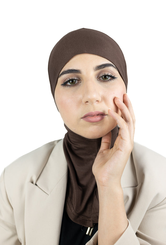muslim woman wearing a beige blazer and brown ninja underscarf