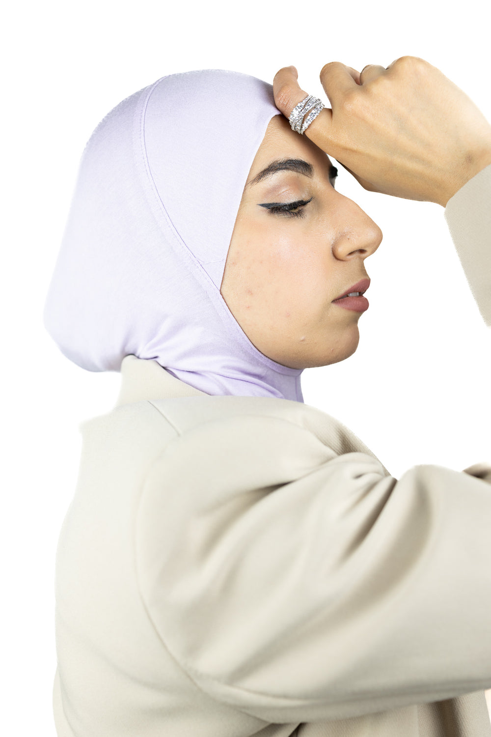 muslim woman wearing a beige blazer and lilac purple ninja underscarf