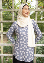 gray dandelion printed top with simple elastic sleeves, a collar, and three buttons  Edit alt text