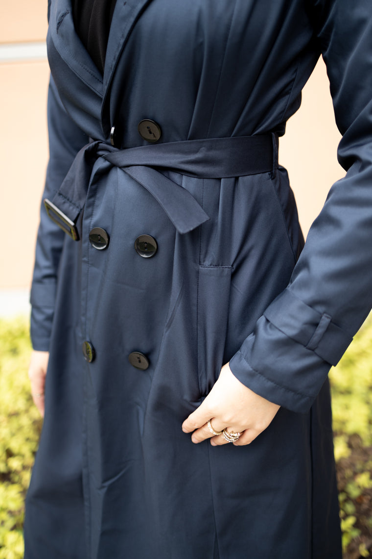 navy blue trench coat with buttons and a waist tie