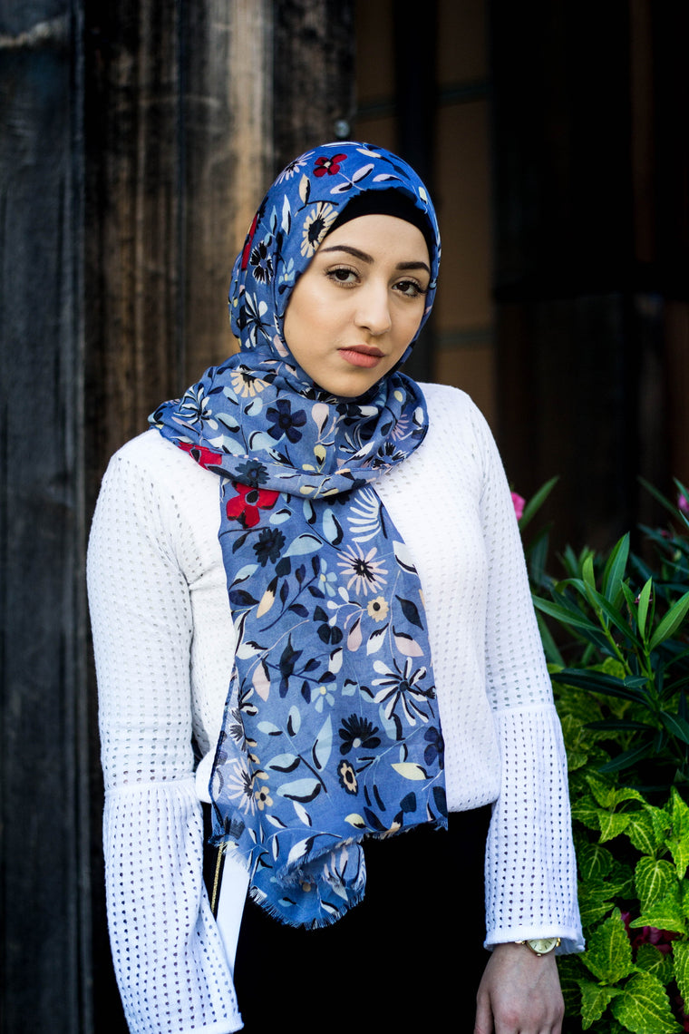 blue hijab with floral prints in multiple colors: yellow, red, blue, green, and pink