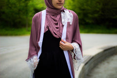 woman wearing an abaya in mauve embellished with lace sleeves and a matching hijab