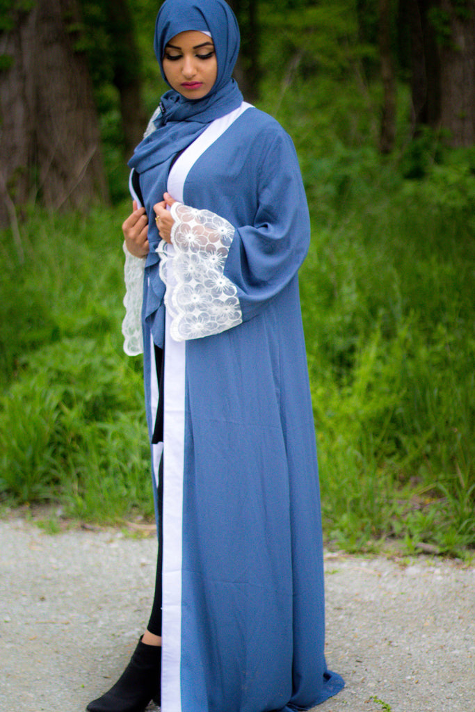woman wearing an abaya in blue embellished with lace sleeves and a matching hijab