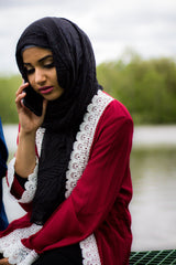 woman wearing an abaya in red embellished with white lace sleeves