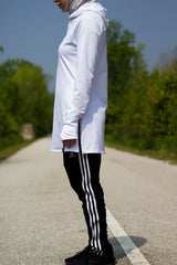 white workout top with long sleeves and a hijab attached on a muslim woman working out outside